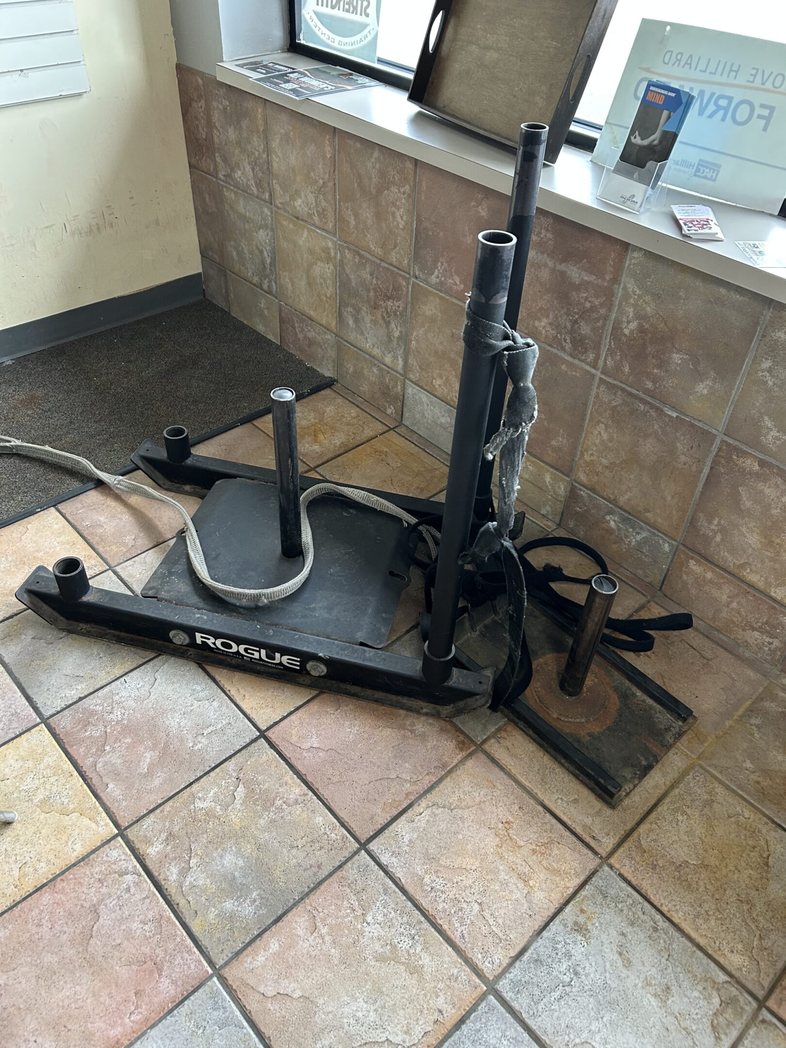 Sled Pic A floor mounted vacuum cleaner sitting on top of tile.
