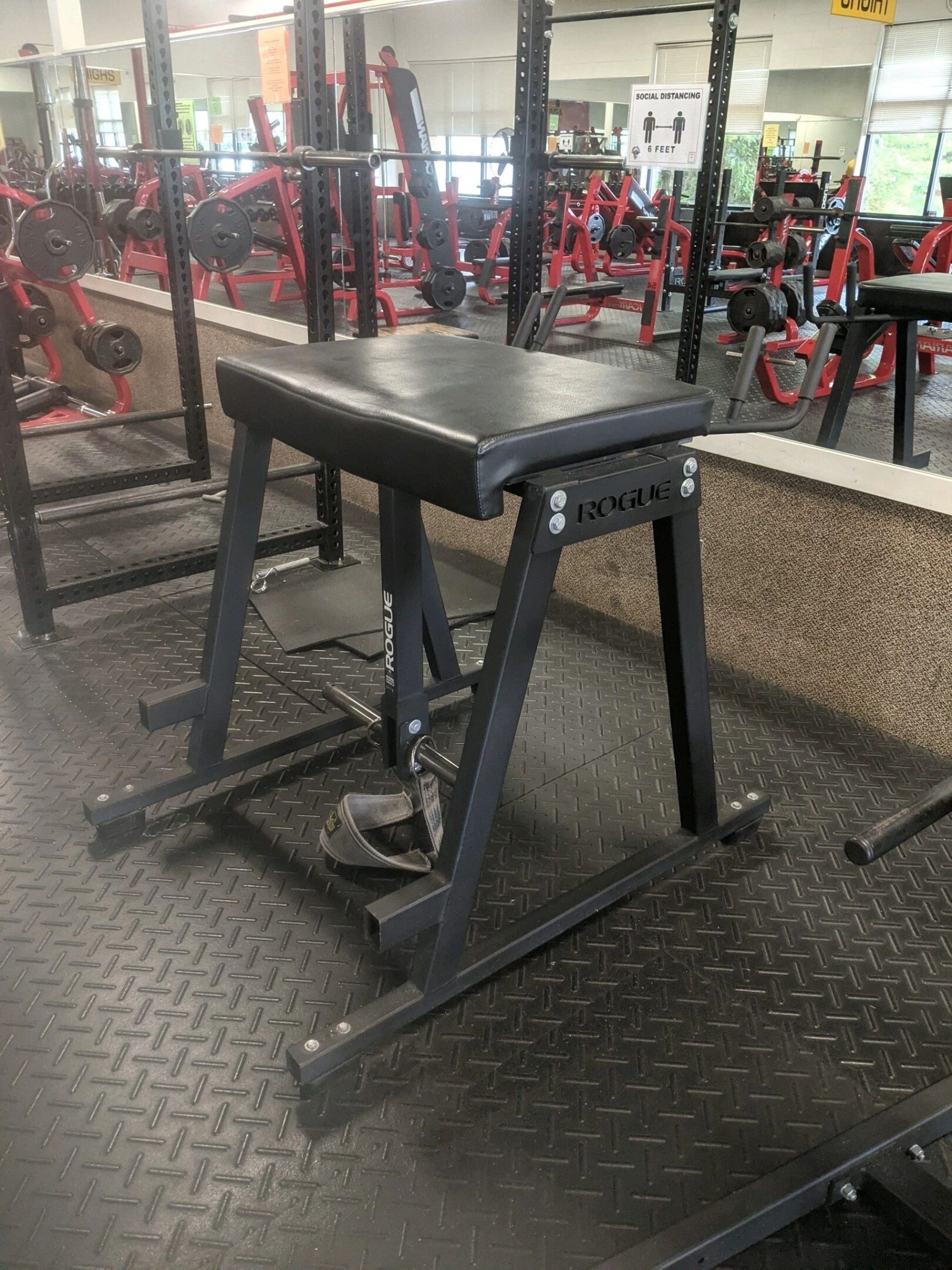 A bench in the middle of a gym.