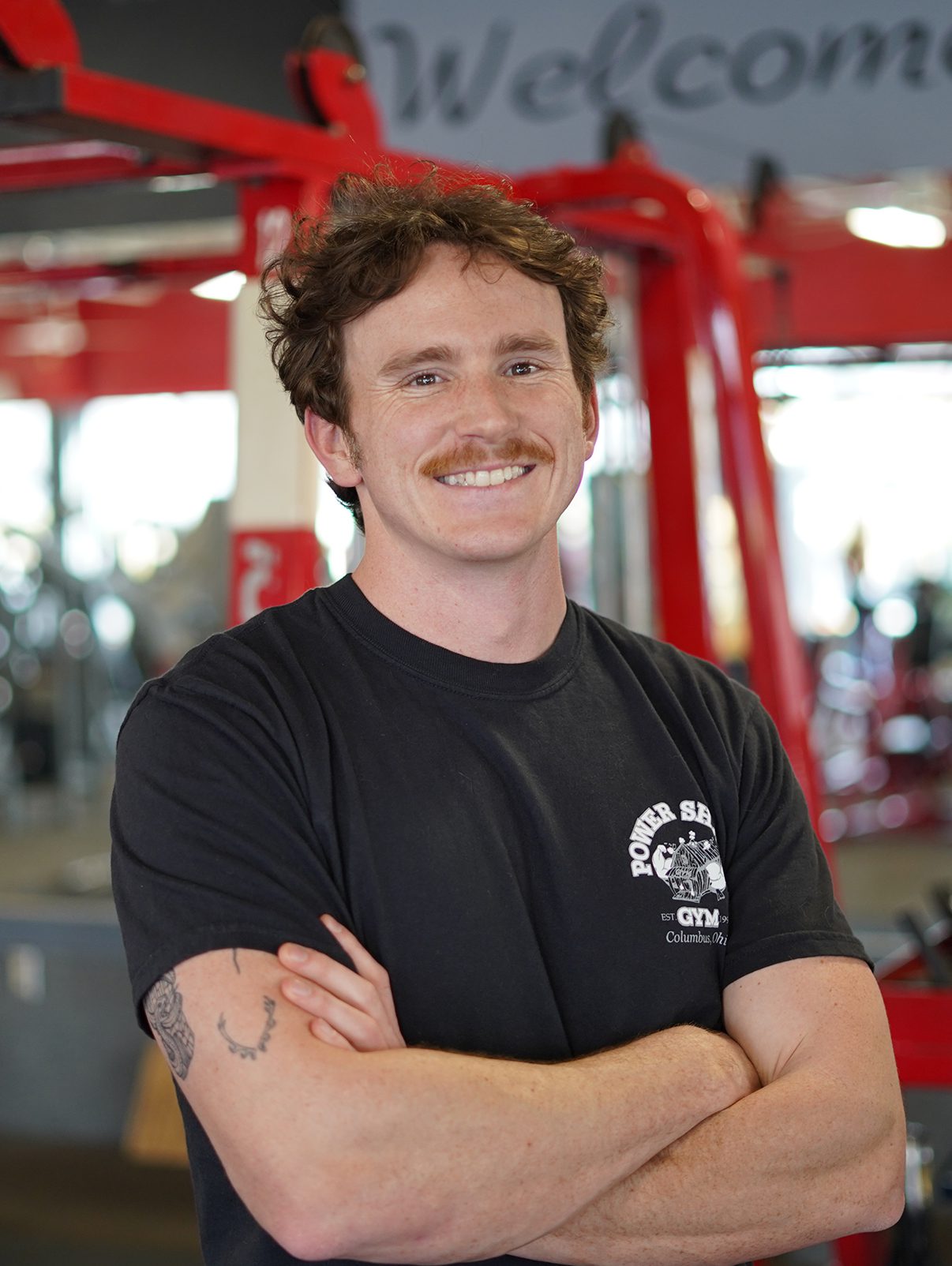 _0003_680277e71ddba_Hayden Cartt Grove CIty A man with his arms crossed in the gym.