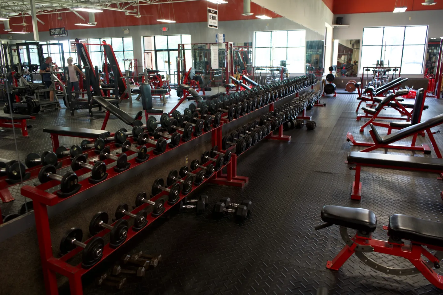 rs=w_1440,h_1440 A gym with many rows of dumbbells and benches.