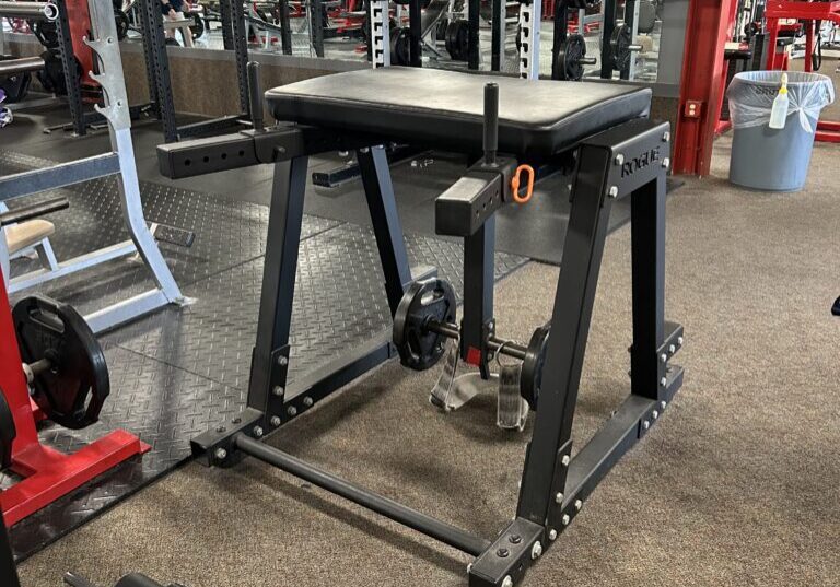 A gym with many machines and equipment in it